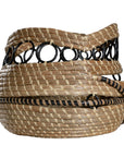 A set of handwoven natural baskets featuring intricate black metal ring detailing and striped accents. Crafted from organic fibres, these versatile storage baskets add a touch of artisanal craftsmanship to any space
