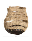A unique handwoven rattan decorative basket with an open-weave design and a dark wooden base. A statement piece that adds texture and organic warmth to any interior