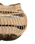 A unique handwoven rattan decorative basket with an open-weave design and a dark wooden base. A statement piece that adds texture and organic warmth to any interior