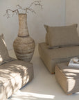 A serene living space featuring a moss modular lounge set, designed for effortless comfort and modern relaxation. Styled with a textured vase and neutral décor, bathed in warm natural light