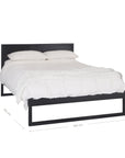 A sleek modern bed frame crafted from black oak, featuring a minimalist open-base design. The bed is styled with crisp white linen and plush pillows, offering a refined and contemporary bedroom aesthetic
