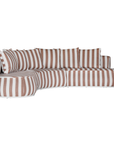 Laguna modular sofa in cinnabar stripe fabric with curved form and soft cushions on a clean background.