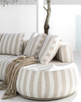 Laguna sofa in sand stripe fabric creating a relaxed coastal outdoor setting.