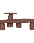 Lantara coffee table cluster in cinnabar clay finish with elongated oval top and three rounded sculptural legs.