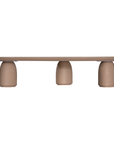 Lantara coffee table large in nomad dune finish with elongated oval top and three rounded sculptural legs.