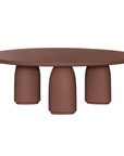 Lantara coffee table in cinnabar clay finish with rounded top and three rounded sculptural legs.