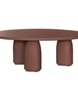 Lantara coffee table in cinnabar clay finish with rounded top and three rounded sculptural legs.