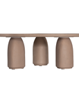 Lantara coffee table small in nomad dune finish with rounded top and three sculptural cylindrical legs.