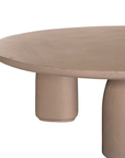 Lantara coffee table small in nomad dune finish with rounded top and three sculptural cylindrical legs.