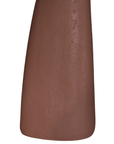 Lantara side table in a cinnabar clay finish with round top and elongated sculptural leg.