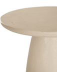 Lantara side table in driftstone finish with sculptural pedestal base and soft rounded top.