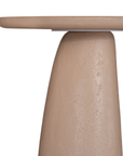 Lantara side table in nomad dune with tapered sculptural base and rounded top shown in a clean minimal setting.