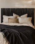 Latte bedhead black styled with layered linen bedding in a modern organic mediterranean inspired australian bedroom