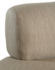 A contemporary latte upholstered lounge chair with a low-profile design and curved backrest. This modern, armless seating piece features a smooth, rounded silhouette, making it a stylish and comfortable addition to any living space