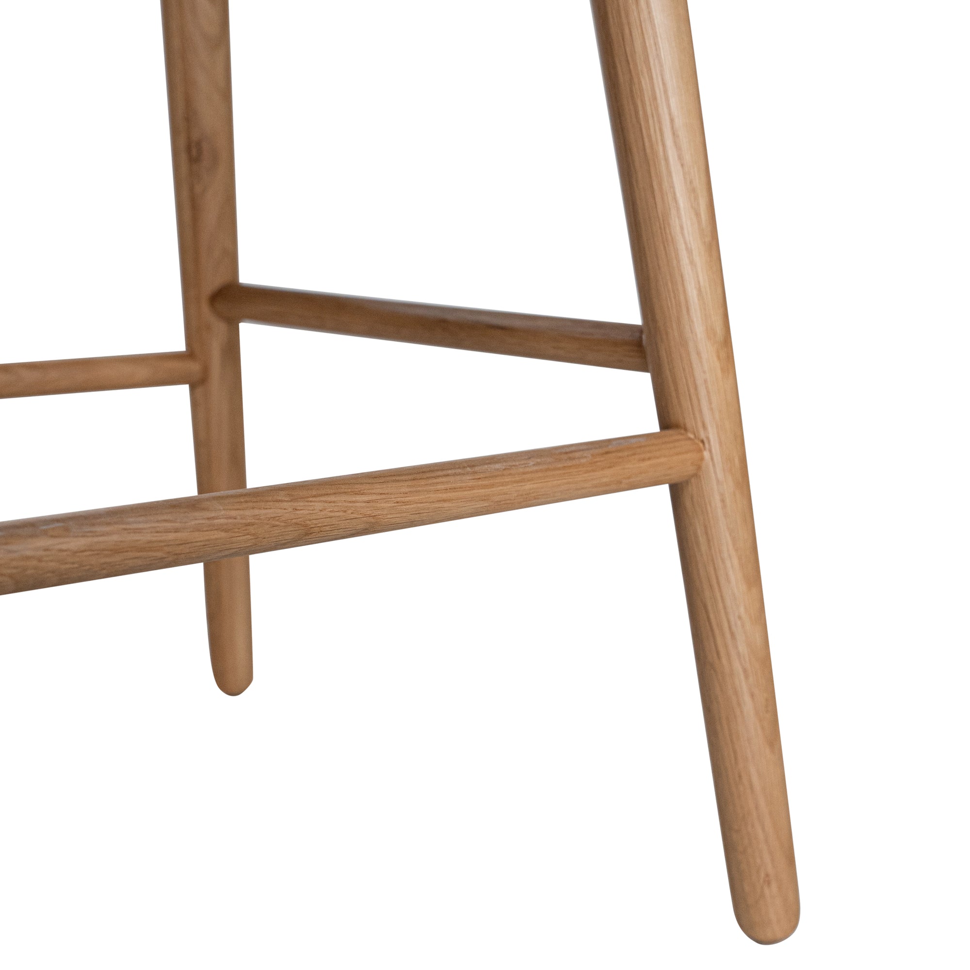 A stylish bar stool featuring a smooth tan leather seat and a sturdy natural oak frame. Designed with comfort and durability in mind, this contemporary stool is perfect for modern kitchens and dining spaces.