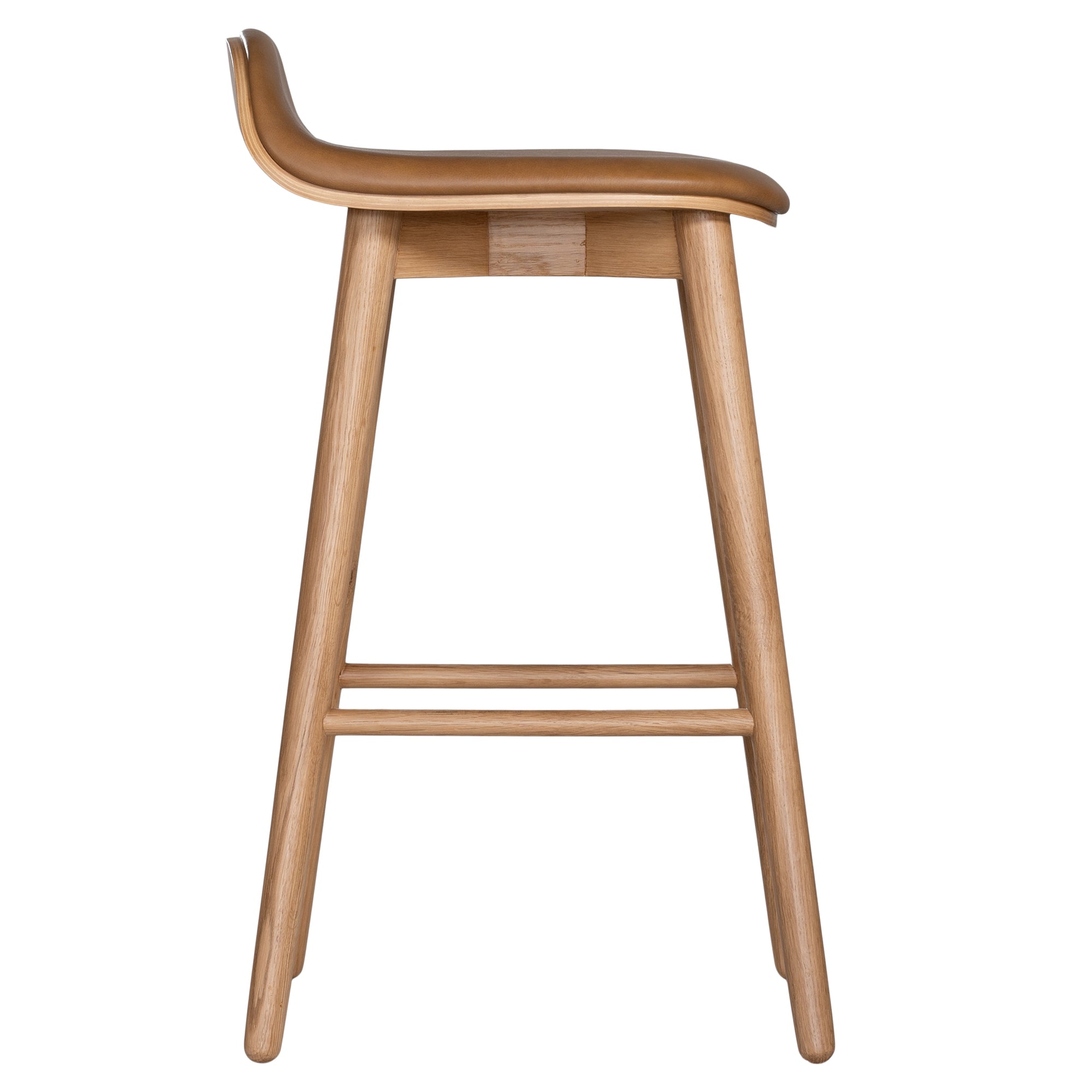 A stylish bar stool featuring a smooth tan leather seat and a sturdy natural oak frame. Designed with comfort and durability in mind, this contemporary stool is perfect for modern kitchens and dining spaces.