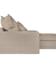 Linen slipcover sectional sofa, designed for effortless comfort and relaxed elegance. Features a modular design with plush cushions and a timeless neutral hue