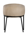 Lumo dining chair in bone with soft upholstered seat and curved backrest on slim black legs shown in a clean minimal setting.