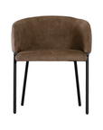 Lumo dining chair in cocoa with soft upholstered seat and curved backrest on slim black legs shown in a clean minimal setting.