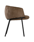 Lumo dining chair in cocoa with soft upholstered seat and curved backrest on slim black legs shown in a clean minimal setting.
