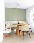 KULALA Living Lumo Dining Chairs and Kuba Oak Dining Table styled with Gaya and Harvest Cushions, Mayi Bowl and Kivu Vase in a sunlit coastal dining nook with curved seating.