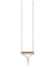 A handcrafted wooden swing with intricate macramé rope detailing, designed for indoor or outdoor relaxation. The bohemian-inspired hanging seat adds a natural, playful element to any space