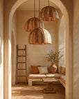 Mawunza Pendant lights by KULALA Living, handcrafted from natural materials, styled in an arched Mediterranean-inspired interior with soft neutral tones and timber accents