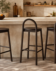 Milo Barchair Espresso lined along a stone kitchen island in a warm modern organic australian interior