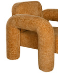 A modern sculptural armchair with rounded, chunky arms and backrest, upholstered in mustard boucle fabric, perfect for contemporary living spaces