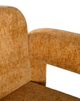 A modern sculptural armchair with rounded, chunky arms and backrest, upholstered in mustard boucle fabric, perfect for contemporary living spaces