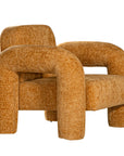 A modern sculptural armchair with rounded, chunky arms and backrest, upholstered in mustard boucle fabric, perfect for contemporary living spaces