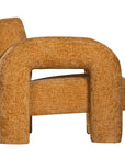 A modern sculptural armchair with rounded, chunky arms and backrest, upholstered in mustard boucle fabric, perfect for contemporary living spaces