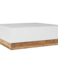 A contemporary white coffee table with a rustic wooden base, featuring a minimalist block design. This versatile piece blends modern aesthetics with organic textures, perfect for living spaces that embrace natural materials and clean lines