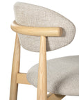 Contemporary wooden barstool with a natural timber frame and an upholstered seat and backrest in neutral fabric, blending comfort and style for modern interiors.