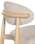 Contemporary wooden dining chair with a natural timber frame and an upholstered seat and backrest in neutral fabric, blending comfort and style for modern interiors.