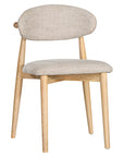 Contemporary wooden dining chair with a natural timber frame and an upholstered seat and backrest in neutral fabric, blending comfort and style for modern interiors.