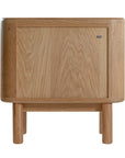 Molly Bedside Table in natural oak with rounded edges and two drawers, styled in a minimalist bedroom setting