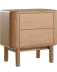 Molly Bedside Table in natural oak with rounded edges and two drawers, styled in a minimalist bedroom setting
