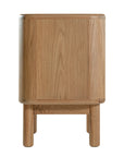 Molly Bedside Table in natural oak with rounded edges and two drawers, styled in a minimalist bedroom setting