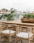 Nakula rattan dining chairs styled around a timber outdoor table in a relaxed mediterranean inspired australian setting