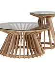 Nakuru side table in natural teak with round glass top and sculptural slat base isolated on a light background