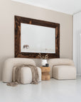 Nash Armchairs in natural upholstery styled with a timber side table, ceramic vase, and elephant wall art in a bright, whitewashed interior