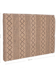 A natural handwoven bedhead featuring intricate geometric patterns, crafted from durable natural fibres for a timeless and earthy aesthetic.