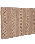 A natural handwoven bedhead featuring intricate geometric patterns, crafted from durable natural fibres for a timeless and earthy aesthetic.