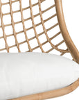 A stylish natural hanging chair with an open-weave design, suspended by a natural rope and featuring a plush white cushion for ultimate relaxation