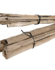 Natural eucalyptus pole bundles tied with black twine, perfect for adding rustic charm and coastal style to home decor