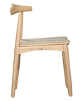 Kulala Living natural wood dining chair featuring a sculpted backrest and a lightly upholstered seat in a neutral fabric. A blend of minimalist design and organic materials, perfect for modern dining spaces.