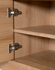 Natural oak TV unit featuring a sleek curved design with ample storage, including cabinets, a drawer, and an open shelf for media organisation