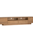 Natural oak TV unit featuring a sleek curved design with ample storage, including cabinets, a drawer, and an open shelf for media organisation
