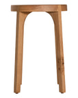 A sleek natural oak round stool featuring a minimalist design with subtly curved legs. Crafted from solid oak with a clear finish, this versatile piece functions as a stool or side table, adding a modern touch to any space